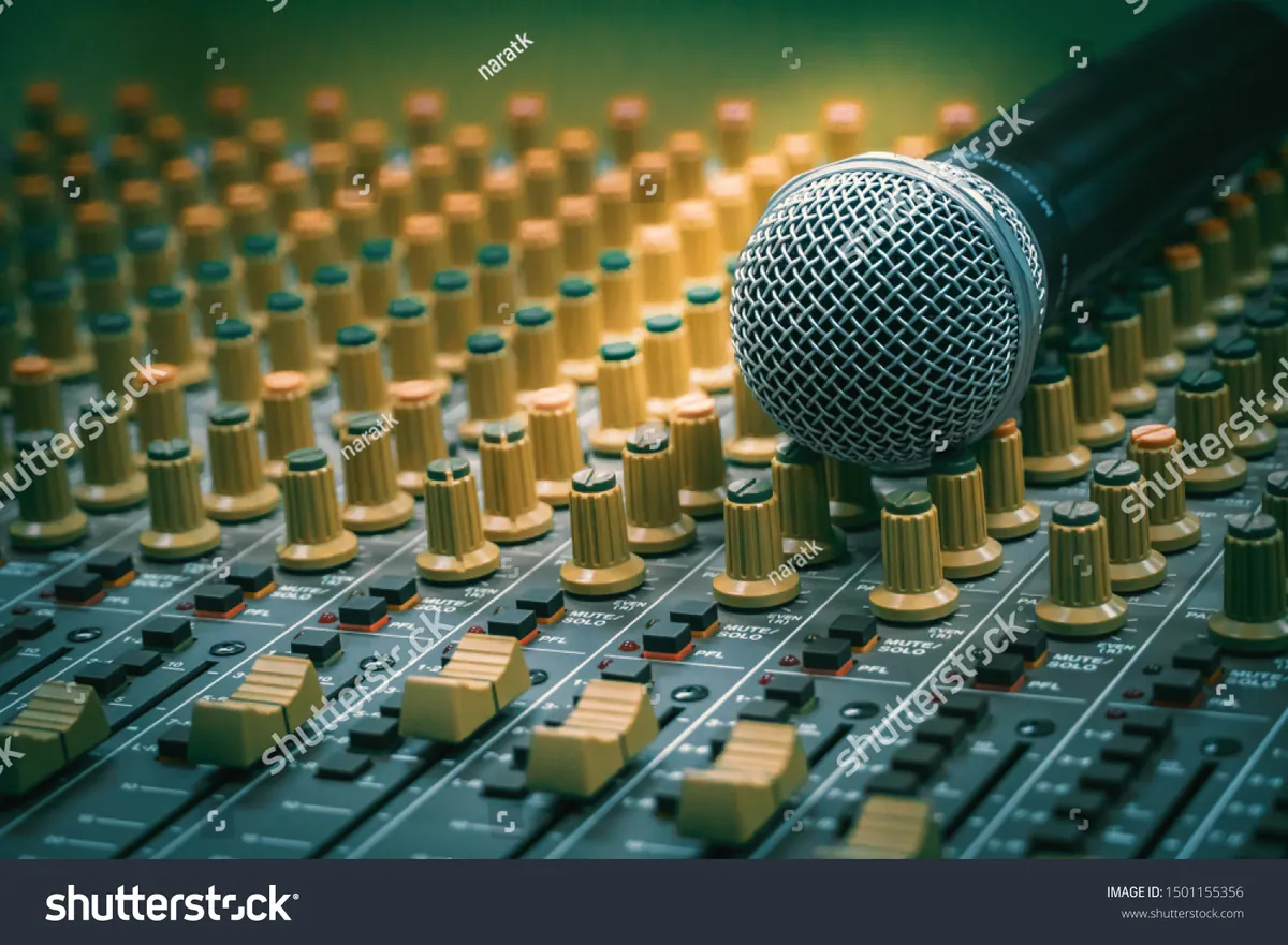 Studio microphone beside a professional audio mixing console